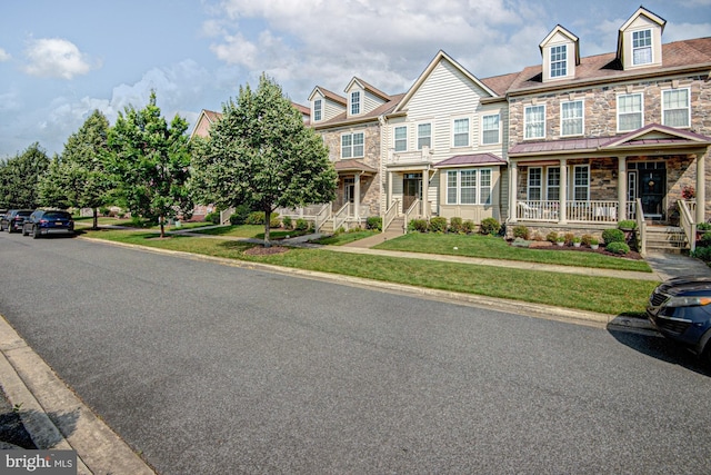 1814 S Pollock Way, Middletown, DE 19709 - townhome / multi-family property with stone siding, a porch, and a front lawn