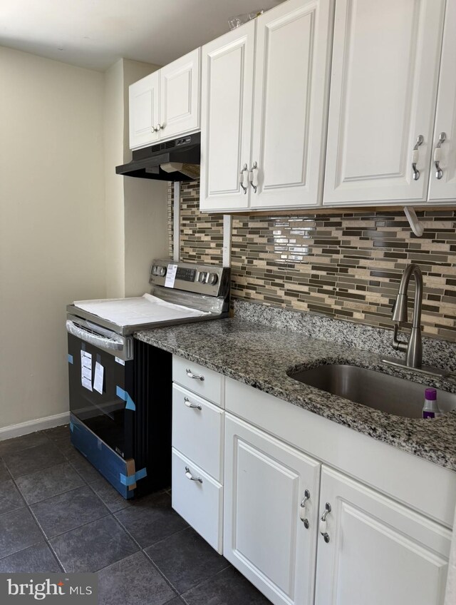 669 Long Ln, Upper Darby, PA 19082 - kitchen featuring electric stove, under cabinet range hood, decorative backsplash, white cabinets, and stone counters