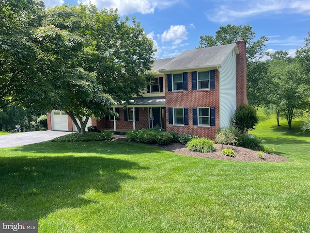 3205 Newfane Ct, Baldwin, MD 21013 - colonial inspired home with a chimney, a front lawn, concrete driveway, brick siding, and a garage