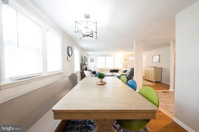 6 W 11th St, Barnegat Light, NJ 08006 - dining space with wood finished floors and a chandelier
