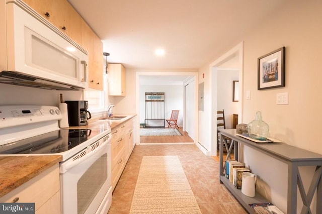 6 W 11th St, Barnegat Light, NJ 08006 - kitchen with white appliances, light tile patterned flooring, and light countertops
