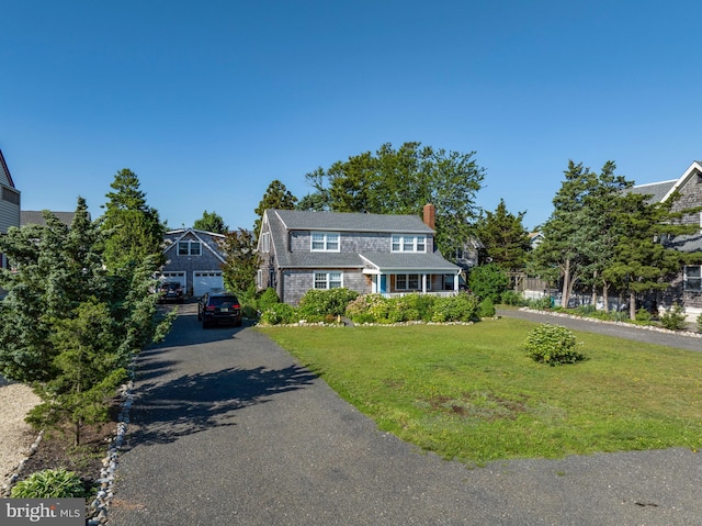 6 W 11th St, Barnegat Light, NJ 08006 - view of front of home featuring a chimney, a front yard, driveway, and a detached garage