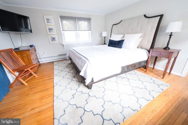 6 W 11th St, Barnegat Light, NJ 08006 - bedroom with a baseboard heating unit, wood finished floors, and ornamental molding