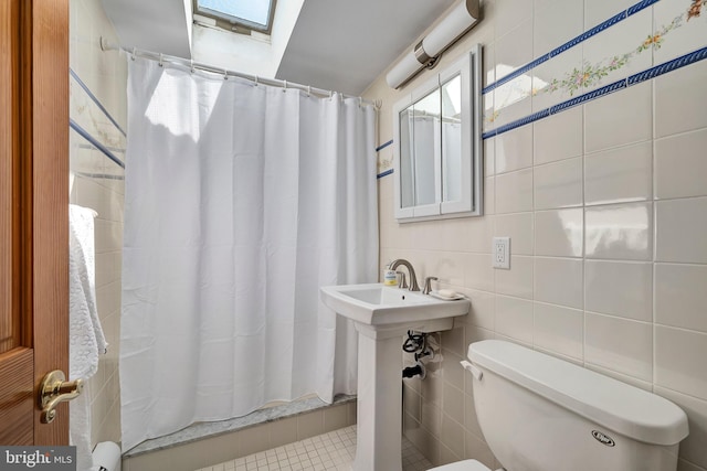 6 W 11th St, Barnegat Light, NJ 08006 - bathroom with a skylight, a shower with shower curtain, and tile walls
