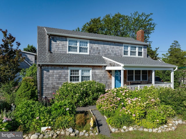6 W 11th St, Barnegat Light, NJ 08006 - view of front facade featuring a chimney, a porch, and roof with shingles