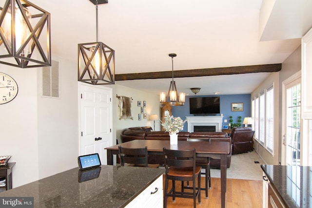 5997 Florey Rd, Hanover, MD 21076 - dining space with light wood-style floors, a fireplace, beam ceiling, and a chandelier