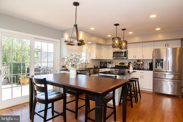 5997 Florey Rd, Hanover, MD 21076 - kitchen with appliances with stainless steel finishes, plenty of natural light, white cabinets, recessed lighting, and dark wood-style flooring