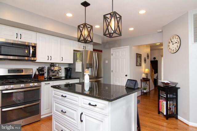 5997 Florey Rd, Hanover, MD 21076 - kitchen featuring stainless steel appliances, light wood-type flooring, a center island, white cabinets, and dark stone countertops