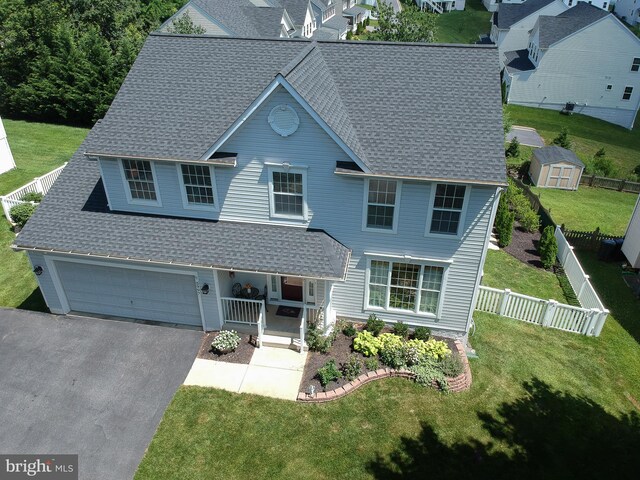 5997 Florey Rd, Hanover, MD 21076 - view of front of property featuring covered porch, asphalt driveway, a shingled roof, and a storage shed