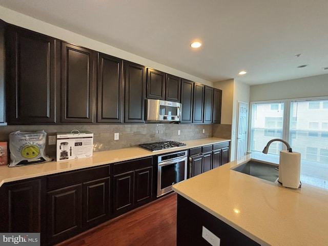 3052 Rittenhouse Cir Unit 52, Fairfax, VA 22031 - kitchen featuring appliances with stainless steel finishes, light countertops, backsplash, recessed lighting, and dark wood finished floors