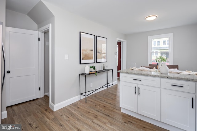 8207 Rockdale Ave, Baltimore, MD 21244 - kitchen featuring white cabinets, light wood finished floors, and light stone countertops