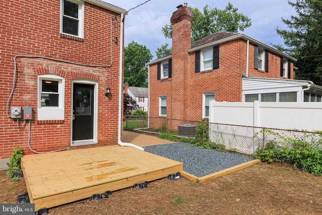 8207 Rockdale Ave, Baltimore, MD 21244 - back of property with a wooden deck, a chimney, and brick siding