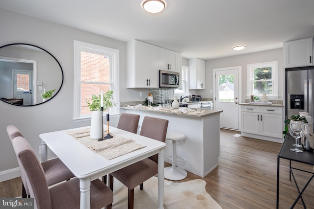 8207 Rockdale Ave, Baltimore, MD 21244 - kitchen featuring appliances with stainless steel finishes, white cabinets, and light wood-style flooring