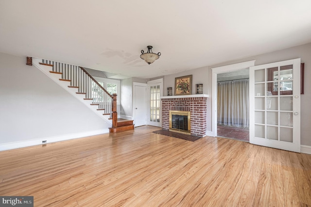 220 N Rolling Rd, Springfield, PA 19064 - unfurnished living room featuring stairs, wood finished floors, and a brick fireplace