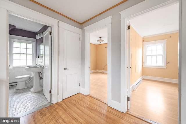 220 N Rolling Rd, Springfield, PA 19064 - hall featuring ornamental molding, wood finished floors, and a baseboard heating unit