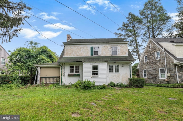 220 N Rolling Rd, Springfield, PA 19064 - back of house with a lawn, a chimney, an attached garage, and stucco siding