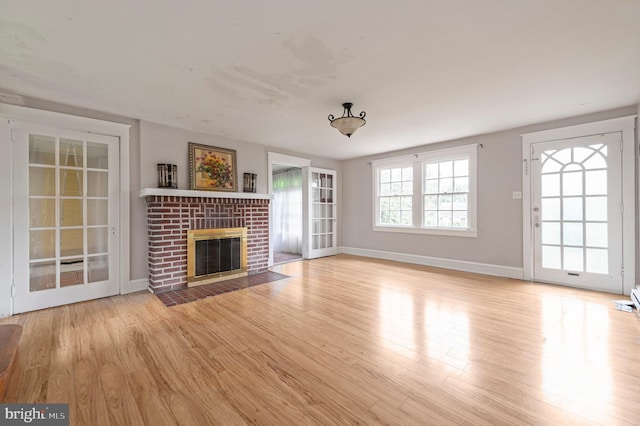 220 N Rolling Rd, Springfield, PA 19064 - unfurnished living room with wood finished floors and a brick fireplace