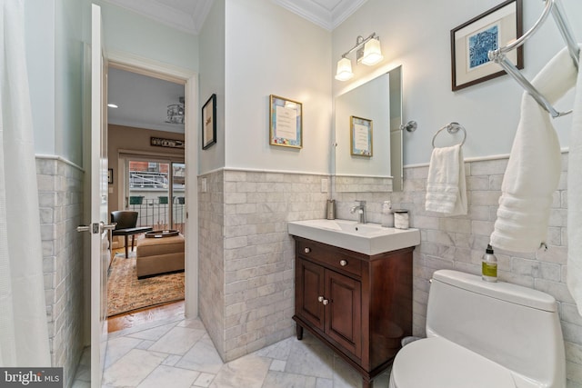 1530 15th St NW, Washington, DC 20005 - bathroom with crown molding, tile walls, vanity, and a wainscoted wall