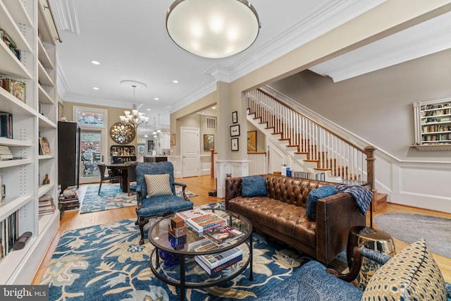 1530 15th St NW, Washington, DC 20005 - living area featuring stairway, light wood finished floors, ornamental molding, wainscoting, and a chandelier