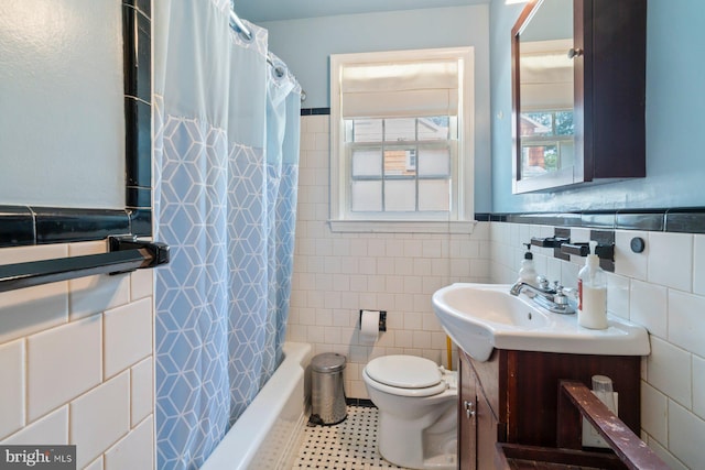 4513 Wards Chapel Rd, Owings Mills, MD 21117 - bathroom featuring tile walls, vanity, tile patterned floors, shower / tub combo, and a wainscoted wall