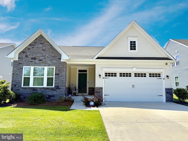 51 Old Forge Dr, Ocean View, DE 19970 - view of front facade featuring stone siding, a front lawn, an attached garage, and concrete driveway
