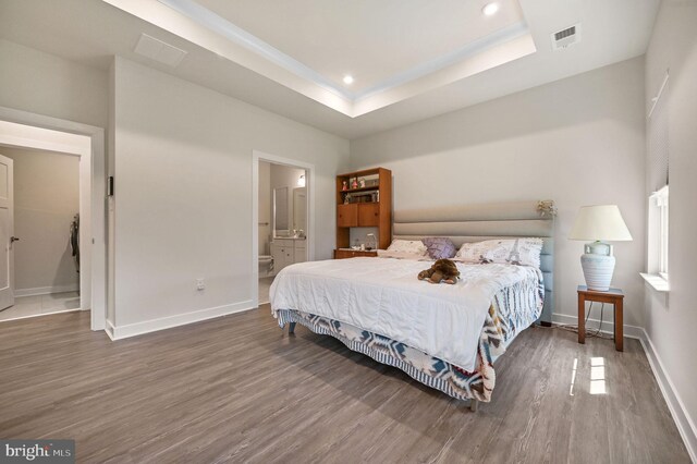 51 Old Forge Dr, Ocean View, DE 19970 - bedroom with wood finished floors, connected bathroom, recessed lighting, and a raised ceiling