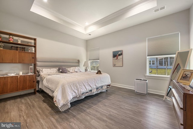 51 Old Forge Dr, Ocean View, DE 19970 - bedroom with dark wood-style floors, a tray ceiling, multiple windows, crown molding, and recessed lighting