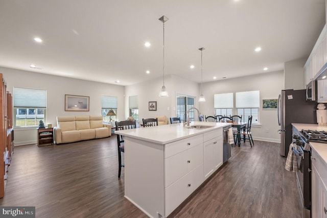 51 Old Forge Dr, Ocean View, DE 19970 - kitchen featuring stainless steel appliances, a breakfast bar area, recessed lighting, white cabinets, and dark wood finished floors