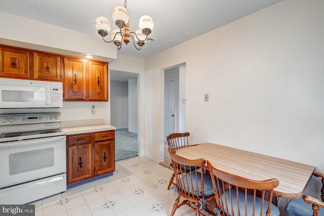 231 Valley Forge Dr, Little Egg Harbor Twp, NJ 08087 - kitchen with white appliances, a chandelier, brown cabinets, light flooring, and light countertops