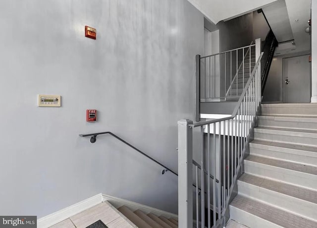 712 Marietta Pl NW Unit 2, Washington, DC 20011 - staircase with baseboards and tile patterned floors