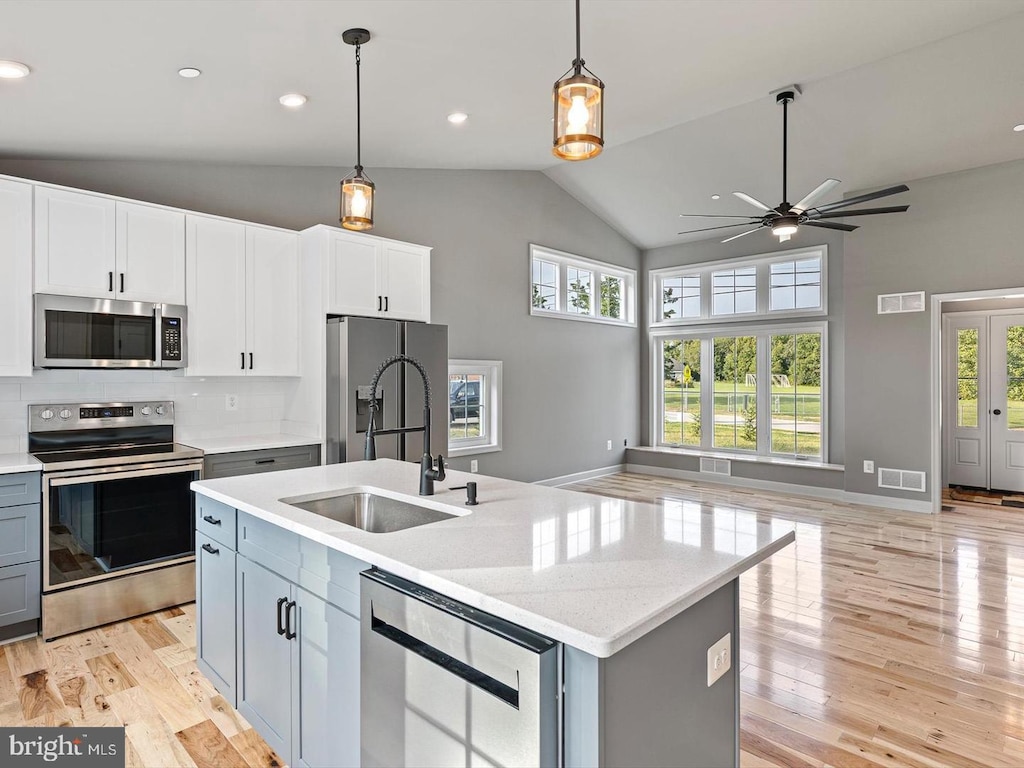 479 Baltimore St, Charlestown, MD 21914 - kitchen with stainless steel appliances, open floor plan, ceiling fan, light wood-style flooring, and high vaulted ceiling