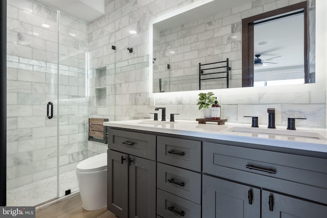1117 Morse St NE Unit 3, Washington, DC 20002 - full bathroom with tile walls, double vanity, a stall shower, a ceiling fan, and wood finished floors