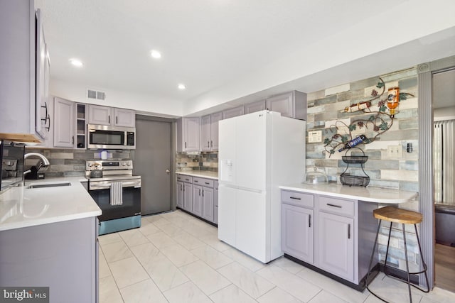31 Gallaway Ln, Willingboro, NJ 08046 - kitchen with appliances with stainless steel finishes, gray cabinets, tasteful backsplash, light countertops, and recessed lighting