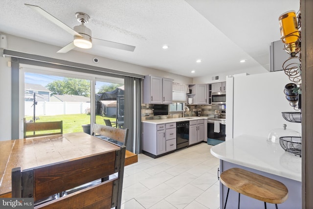 31 Gallaway Ln, Willingboro, NJ 08046 - kitchen featuring stainless steel appliances, gray cabinetry, open shelves, ceiling fan, and light countertops