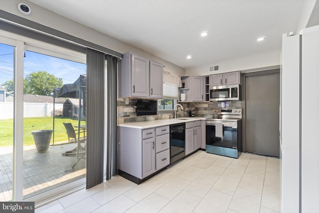 31 Gallaway Ln, Willingboro, NJ 08046 - kitchen with stainless steel appliances, gray cabinets, open shelves, decorative backsplash, and light countertops