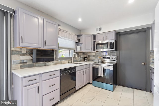 31 Gallaway Ln, Willingboro, NJ 08046 - kitchen with appliances with stainless steel finishes, decorative backsplash, light countertops, open shelves, and gray cabinetry