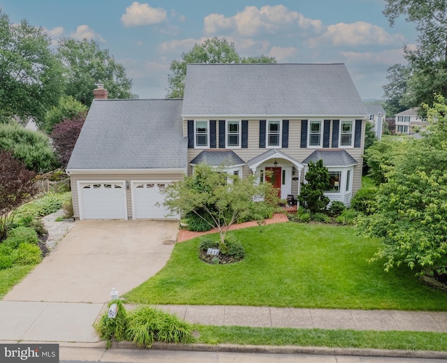 1439 Millikens Bend Rd, Herndon, VA 20170 - colonial home with driveway, an attached garage, a chimney, and a front lawn