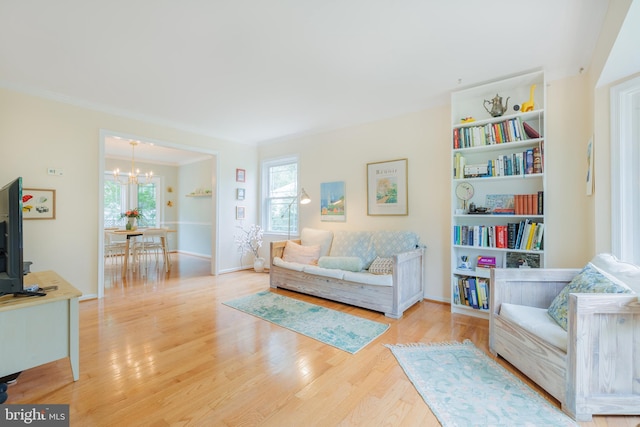 1439 Millikens Bend Rd, Herndon, VA 20170 - living room with a chandelier, healthy amount of natural light, wood finished floors, and ornamental molding