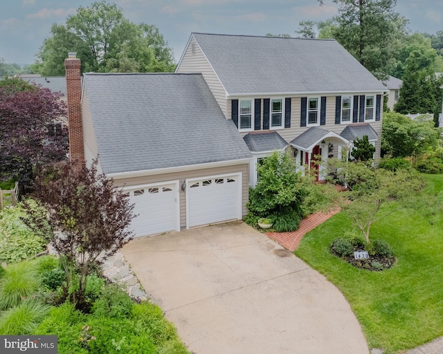 1439 Millikens Bend Rd, Herndon, VA 20170 - colonial house with concrete driveway, an attached garage, a chimney, a front yard, and roof with shingles