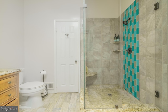 1439 Millikens Bend Rd, Herndon, VA 20170 - bathroom featuring a shower stall, vanity, and wood finished floors