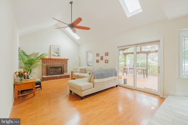 1439 Millikens Bend Rd, Herndon, VA 20170 - living area with a skylight, a ceiling fan, a fireplace, high vaulted ceiling, and wood finished floors