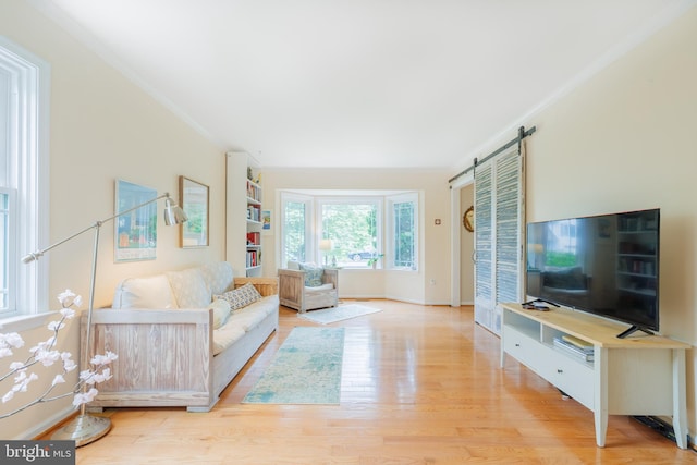1439 Millikens Bend Rd, Herndon, VA 20170 - living room featuring wood finished floors, ornamental molding, and a barn door