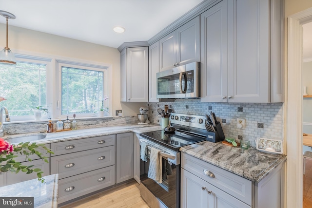 1439 Millikens Bend Rd, Herndon, VA 20170 - kitchen featuring stainless steel appliances, gray cabinetry, light stone counters, tasteful backsplash, and recessed lighting