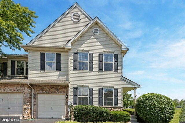 2408 Carriage Ln, Royersford, PA 19468 - view of front facade with an attached garage, stone siding, and driveway
