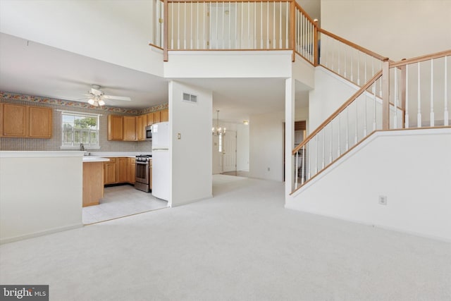 2408 Carriage Ln, Royersford, PA 19468 - kitchen featuring stainless steel appliances, ceiling fan, a high ceiling, light countertops, and light colored carpet