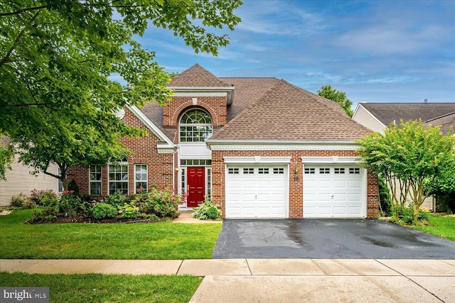 16 Monte Carlo Dr, Hamilton, NJ 08691 - traditional home with a garage, driveway, brick siding, a front lawn, and roof with shingles