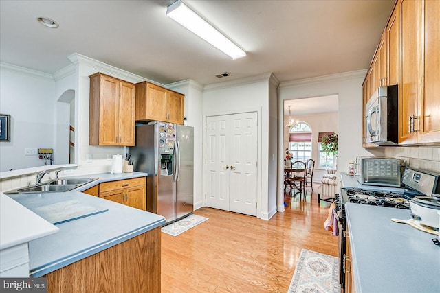 16 Monte Carlo Dr, Hamilton, NJ 08691 - kitchen featuring appliances with stainless steel finishes, ornamental molding, light wood-type flooring, backsplash, and light countertops