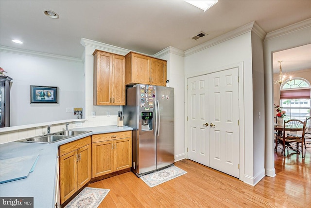 16 Monte Carlo Dr, Hamilton, NJ 08691 - kitchen with stainless steel fridge with ice dispenser, ornamental molding, light wood-style flooring, a chandelier, and light countertops