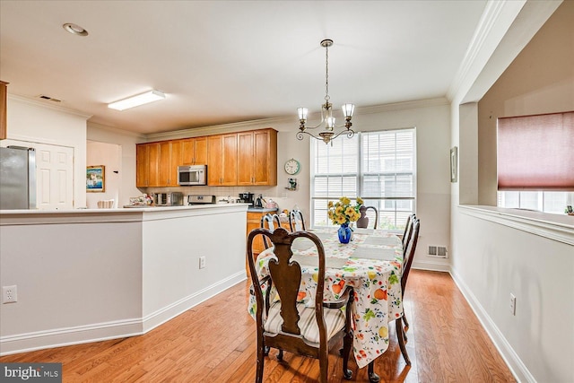 16 Monte Carlo Dr, Hamilton, NJ 08691 - dining space featuring light wood-style floors, ornamental molding, and a chandelier