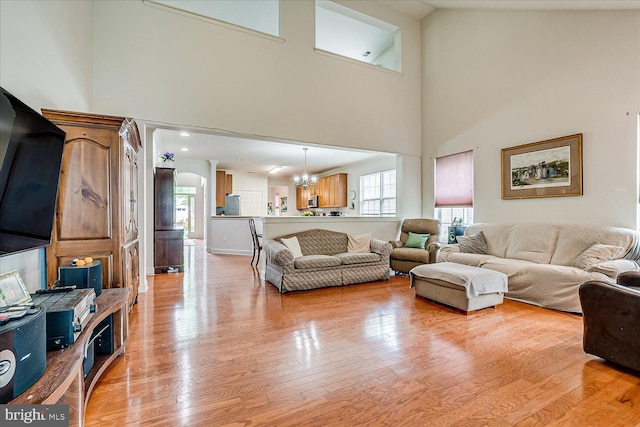 16 Monte Carlo Dr, Hamilton, NJ 08691 - living room with a towering ceiling, light wood-style floors, and a chandelier